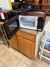 Mainstays 0.7 Cu ft Compact Countertop Microwave Oven, Black!! NEW OUT OF BOX(DENT FROM SHIPPING)!!