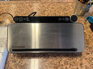 FoodSaver 2110742 Multi-Use Food Preservation System with Built-in Handheld Sealer!! LIGHTLY USED(HAS ALL BAGS AND ABOUT HALF THE STARTER ROLL)!!