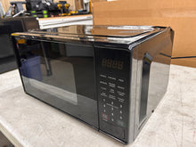 Mainstays 0.7 Cu ft Compact Countertop Microwave Oven, Black!! NEW OUT OF BOX(DENT FROM SHIPPING)!!