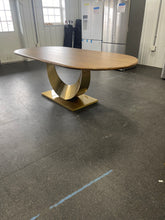 Gorgeous and unique solid wood dining table with massive fabricated brass finish steel base.