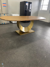 Gorgeous and unique solid wood dining table with massive fabricated brass finish steel base.