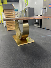 Gorgeous and unique solid wood dining table with massive fabricated brass finish steel base.