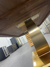 Gorgeous and unique solid wood dining table with massive fabricated brass finish steel base.