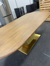 Gorgeous and unique solid wood dining table with massive fabricated brass finish steel base.