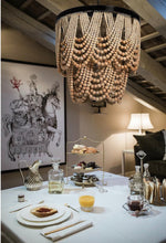 Bring cozy glamour and serious style to your home with this gorgeous 27½” Natural Wood Bead Chandelier!